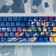 The Higround Summit 65 Gundam Wing keyboard photographed against Gundam Wing schematics.